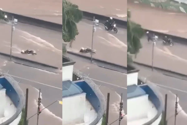 Imagem colorida de motociclista sendo levado por enxurrada