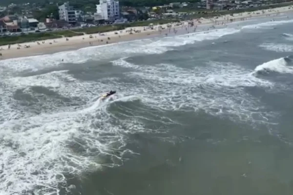 Foto de praia com lancha com bombeiros fazendo socorro - Metrópoles