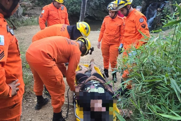 Foto colorida de bombeiros salvando jovem em maca