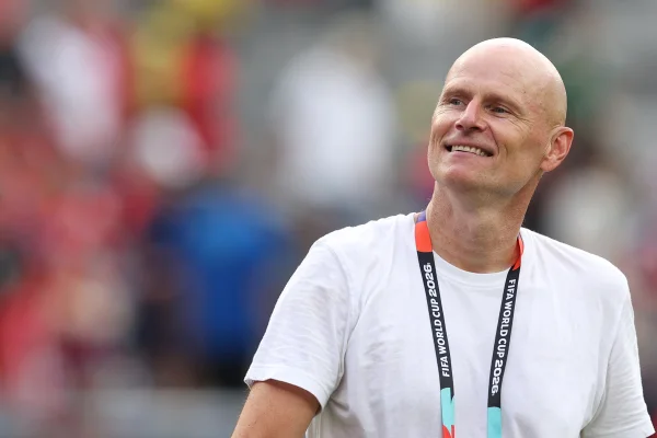 Foto colorida de homem com crachá da Copa do Mundo de 2026 - Metrópoles