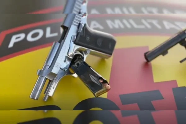 Pistola calibre 38 prata em cima de capô de viatura da polícia