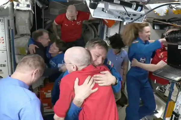 Foto colorida dos astronautas presos no espaço há 9 meses recebendo a equipe de resgate - Metrópoles