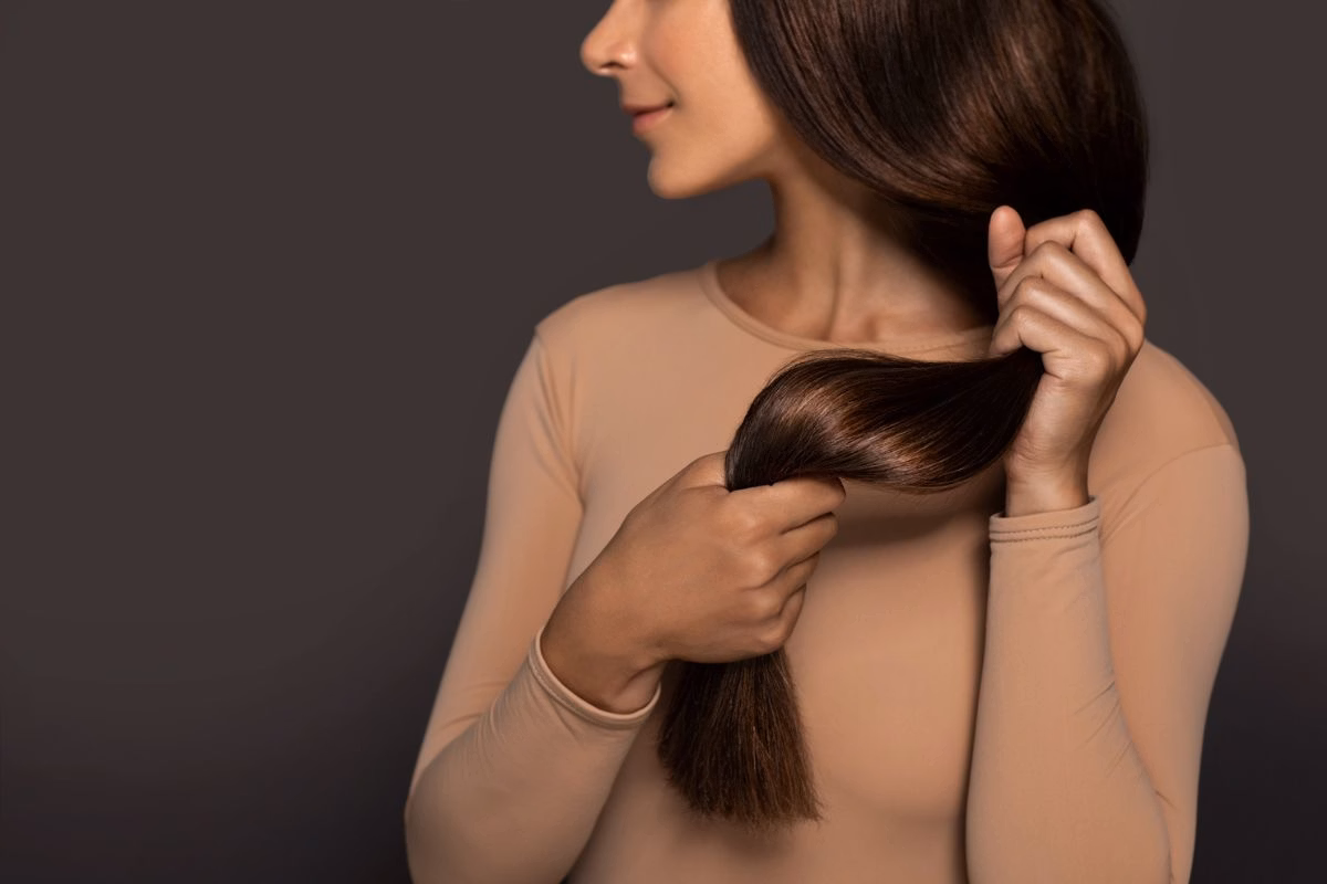 3 máscaras que deixam o cabelo sedoso e com brilho de salão 3 Mulher segurando os cabelos longos