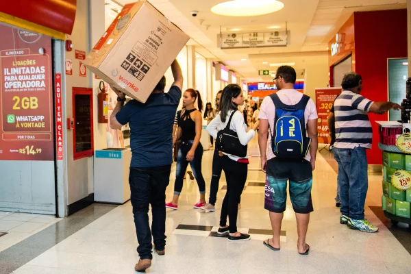 Fotografia colorida mostrando pessoas fazendo compras em shopping-Metrópoles