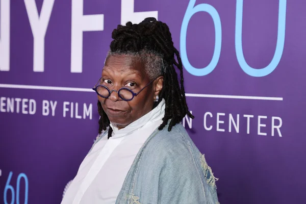Foto colorida de Whoopi Goldberg em fundo roxo - Metrópoles