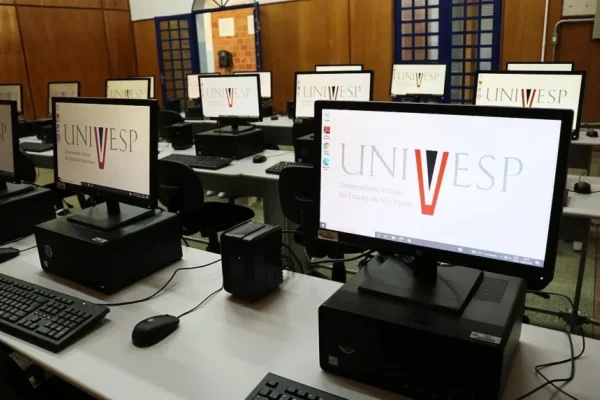 Imagem colorida de computadores com o logo da Univesp
