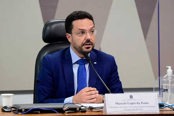 Presidente do FNDE, Marcelo Lopes da Ponte, depõe sobre suposto escândalo de corrupção no Ministério da Educação na Comissão de Educação, Senado. Ele fala diante de um microfone, usando terno - Metrópoles