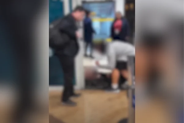 Imagem colorida de homem deitado no portão de embarque. Metrópoles