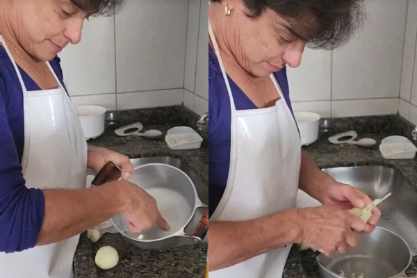 Foto colorida de uma mulher cozinhando - Metrópoles