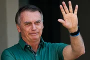 Jair Bolsonaro acenando em frente à à sua casa