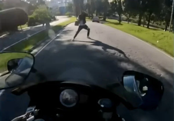 Imagem de homem parado no caminho de motociclista - Metrópoles
