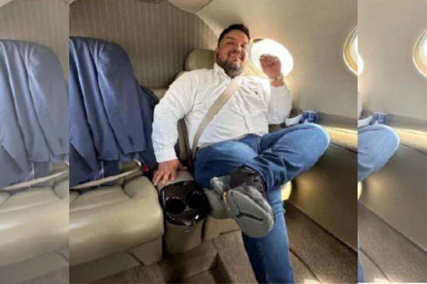 Foto de homem sentando em assento de avião particular, com a perna cruzada - Metrópoles