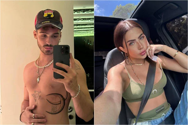 Homem tatuado e sem camisa e de bone com mulher de top e cabelos compridos - Metrópoles