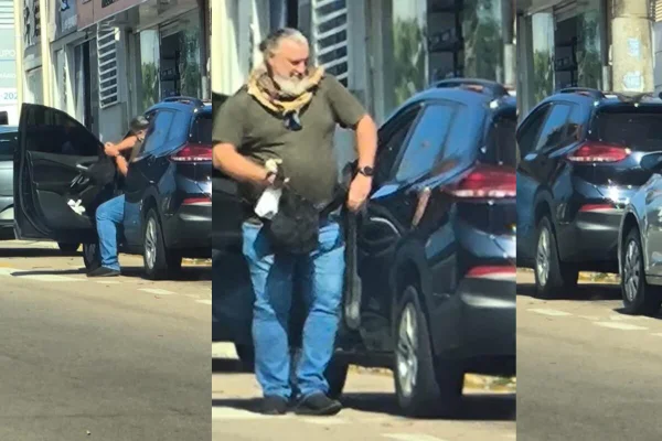 Homem de meia idade, branco, de barba longa branca ao lado de carro - Metrópoles