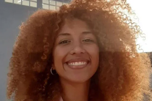 Advogada com cabelo black power aparece sorrindo para foto. Ela foi vítima de injúria racial- Metrópoles