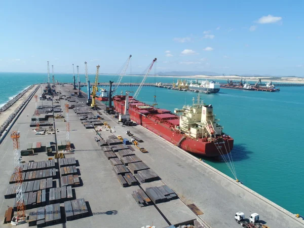 Navio de grande porte recebe movimentação intensa de contêineres no terminal cearense, evidenciando a capacidade logística e a infraestrutura moderna do porto.