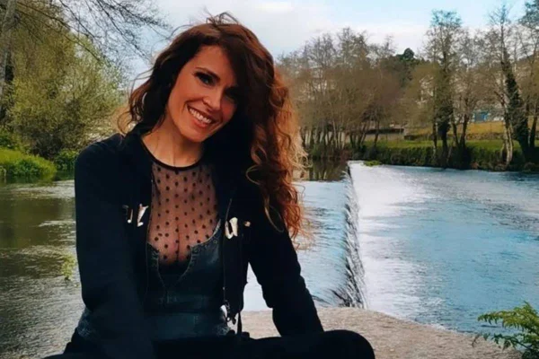 mulher de cabelo cacheado sentada com rio ao fundo - metrópoles