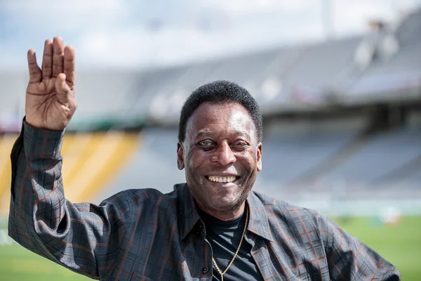 O ex-jogador de futebol Pelé, considerado um dos maiores da história, acena e sorri para foto em estádio - Metrópoles