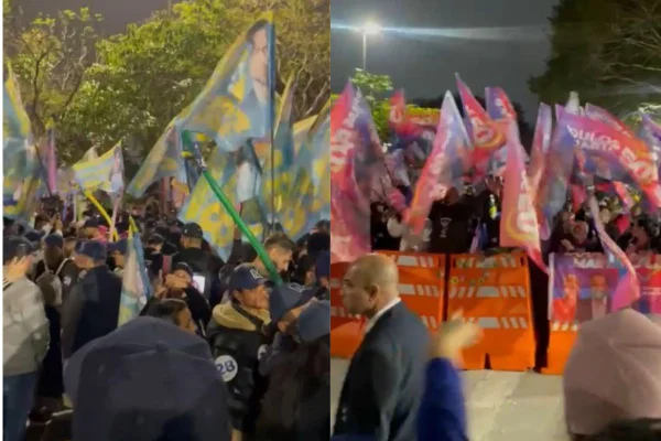Imagem colorida mostra apoiadores de candidatos em frente à TV Globo - Metrópoles