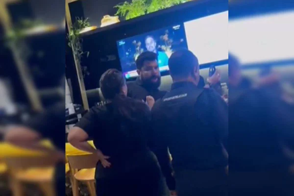 Foto colorida de homem com barba jogando garrafa