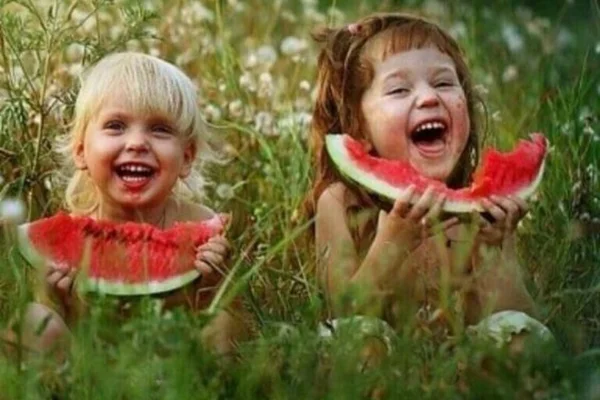 crianças comendo melancia felizes