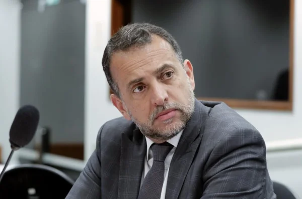 Fotografia colorida de Marco Bertaiolli, homem branco de cabelo e barba grisalhos, com a cabeça levemente inclinada para a esquerda - Metrópoles
