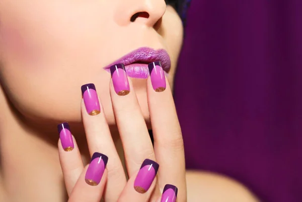 Imagem colorida: mulher mostra alongamento de unhas com mão próxima à boca - Metrópoles