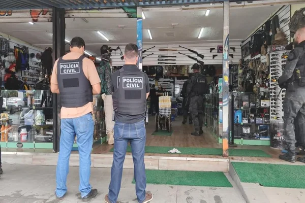 policiais civis de costas em frente à loja de artigos militares