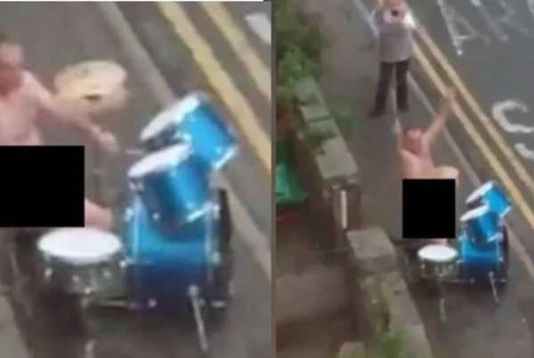 Homem tocando bateria pelado na rua