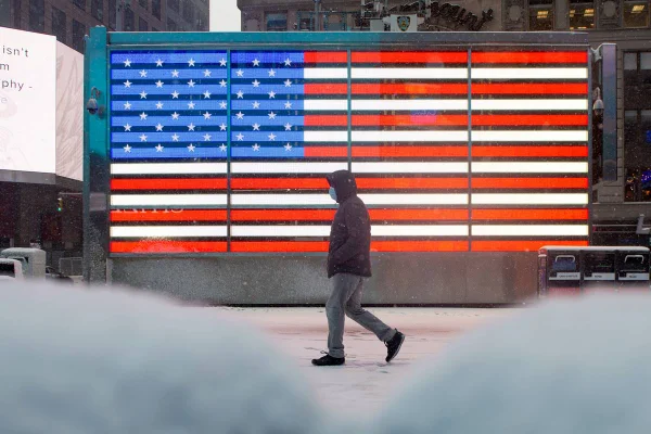 pessoa de máscara em frente à bandeira dos eua