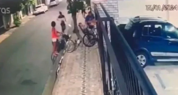 Imagens de câmeras de segurança mostram homem esloveno com criança em bicicleta, acompanhado da mulher, sendo abordado por um criminoso armado em Santos - Metrópoles