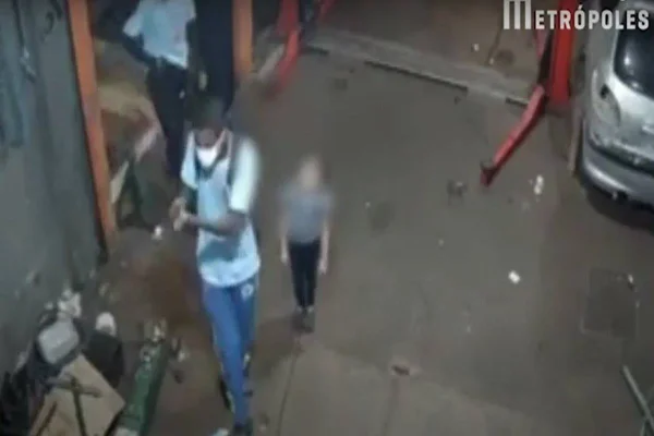 Homem segura arma perto de criança
