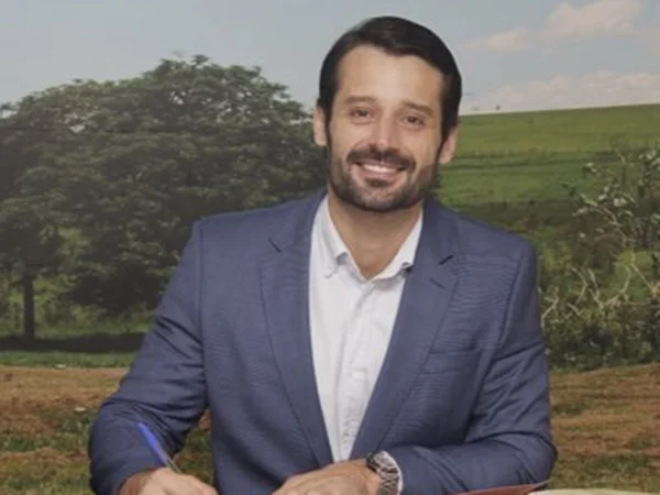 Imagem colorida mostra Guilherme Piai, homem branco de cabelo e barba pretos, de terno - Metrópoles