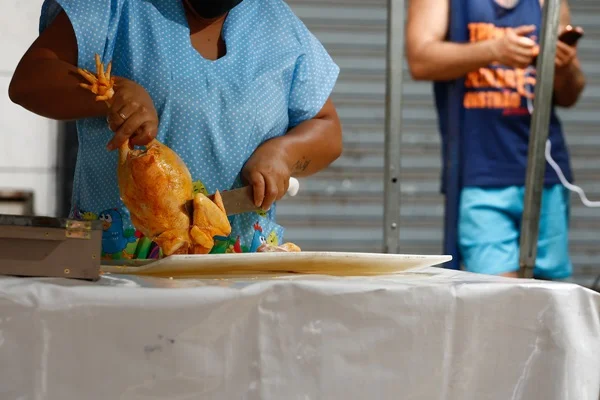 Fotografia colorida de mulher cortando frango