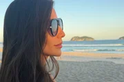 Anamara posa de óculos escuros e cabelos soltos na praia