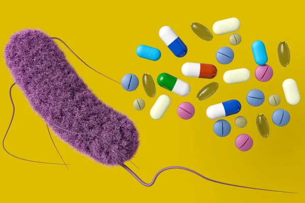 Ilustração conceitual de uma bactéria ao lado de vários tipos de medicamentos, enfatizando o desafio de combater a resistência aos antibióticos. Metrópoles