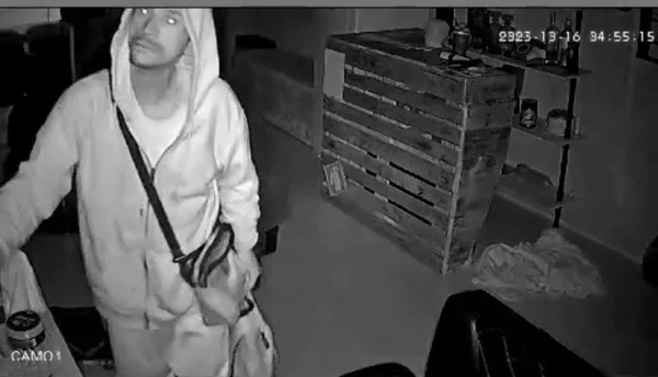 Homem de agasalho com capuz aparece em imagem de câmera de segurança furtando barbearia