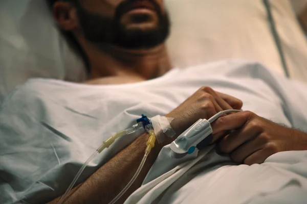 }Imagem colorida de homem em cama hospitalar com curativos e tubos - Metrópoles.