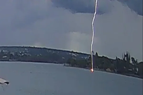 momento exato em que um raio atinge uma canoa no Lago Paranoá