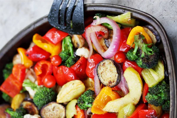 Na foto, diversos legumes coloridos em um recipiente preto - Metrópoles