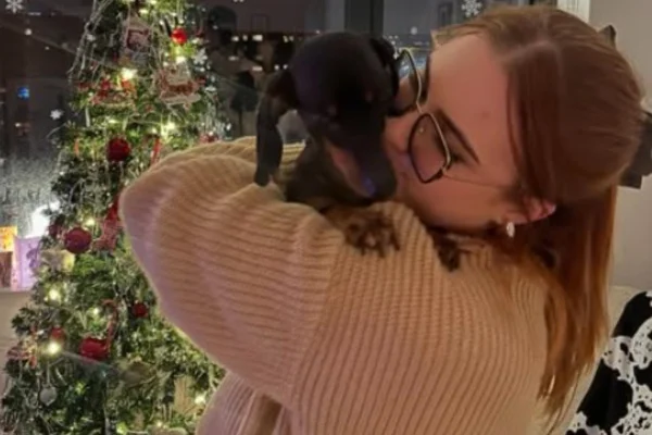 Foto colorida de mulher beijando o cachorro - Metrópoles