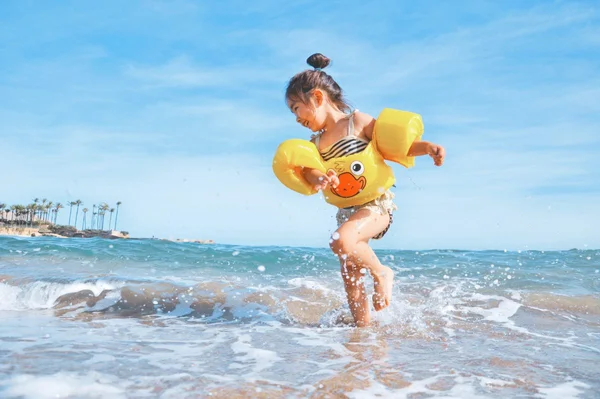 Criança brinca na praia