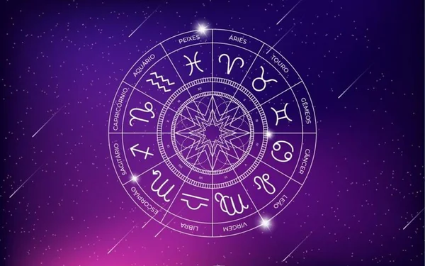 Foto colorida de uma roda onde há símbolos dos signos