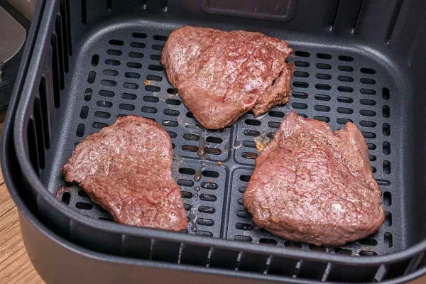 pedaços de carne dentro da air fryer