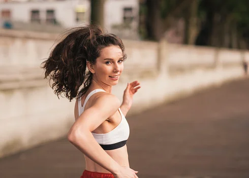 mulher sorrindo enquanto corre