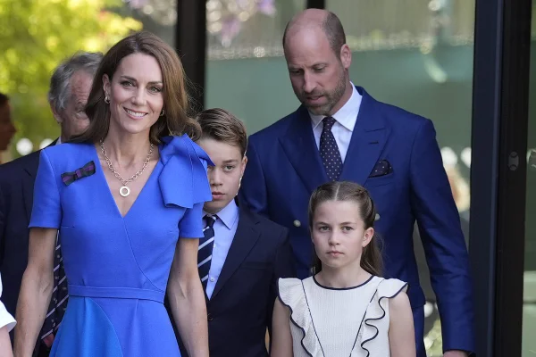 LONDON, ENGLAND - JULY 13: Catherine, Princess of Wales (centre), Princess Charlotte (second right) and Prince William, Prince of Wales (right), are greeted by Sally Ambrose (left), a member of the Committee of Management of The Championships, as they arrive during day fourteen of The Championships Wimbledon 2025 at All England Lawn Tennis and Croquet Club on July 13, 2025 in London, England. (Photo by Andrew Matthews - WPA Pool/Getty Images)