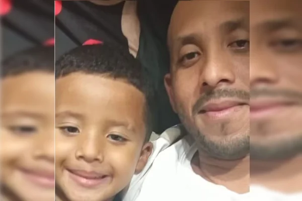 Imagem colorida de criança morta e pai - Metrópoles
