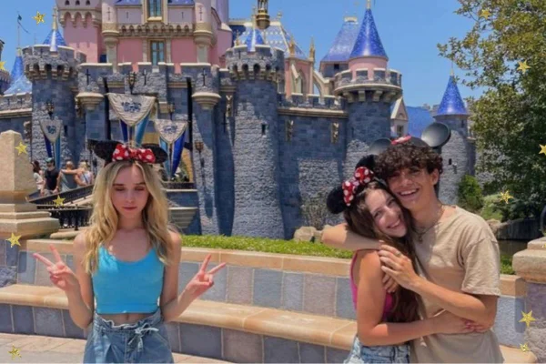 Imagem colorida de tres jovens com dois abraçados