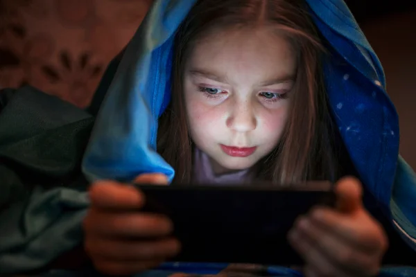 Criança utilizando telas excessivamente e prejudicando saúde ocular