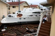 Brenda Brennan se senta ao lado de um barco que empurrou seu apartamento quando o furacão Ian passou pela área em 29 de setembro de 2022 em Fort Myers, Flórida Brenda Brennan se senta ao lado de um barco que empurrou seu apartamento quando o furacão Ian passou pela área em 29 de setembro de 2022 em Fort Myers, Flórida